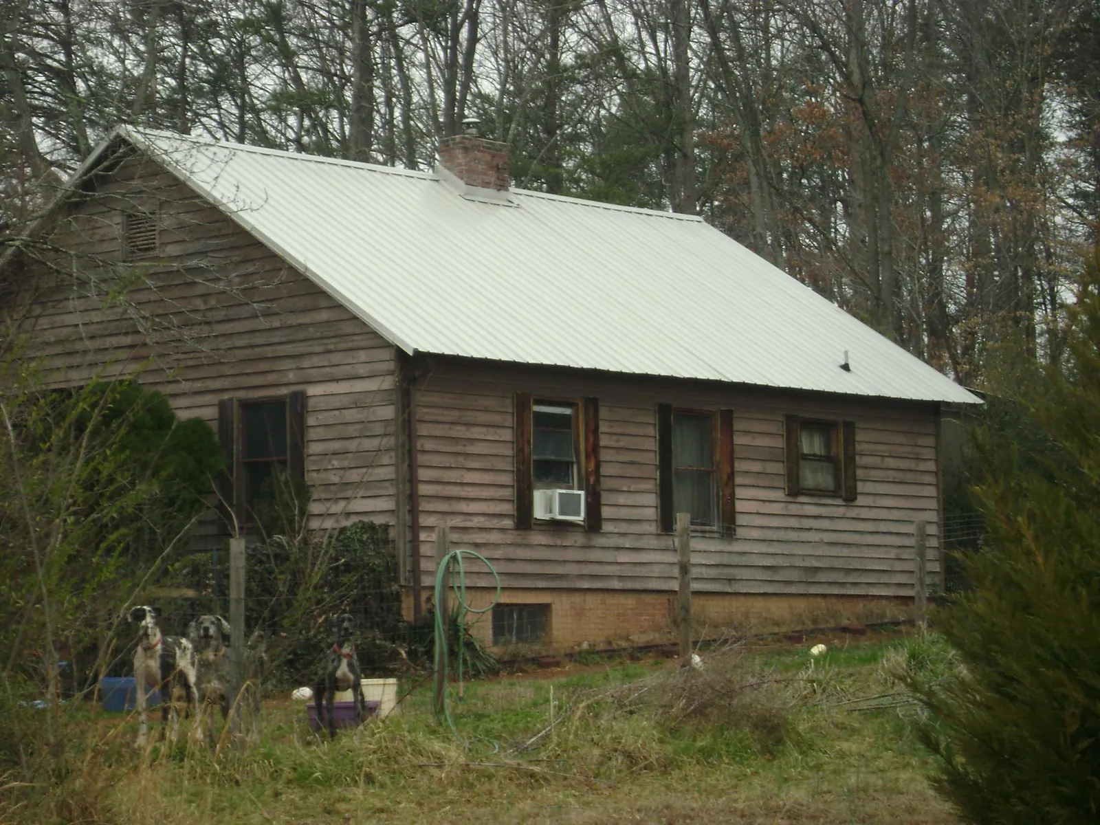 White metal roof on an old wood sided farmhouse, from a Metal Roof Installation job in Royalston
